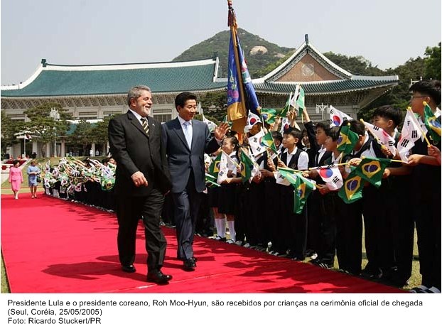 Presidente Lula e o presidente coreano, Roh Moo-Hyun são recebidos por crianças na cerimônia oficial de chegada.