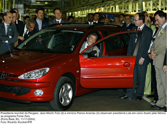 Presidente mundial da Peugeot, Jean-Martin Folz (d) e ministro Patrus Ananias (d) observam presidente Lula em carro doado pela fábrica ao programa Fome Zero.jpg