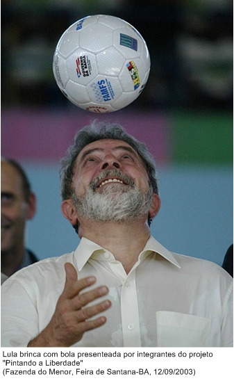 Lula brinca com bola presenteada por integrantes do projeto Pintando a Liberdade